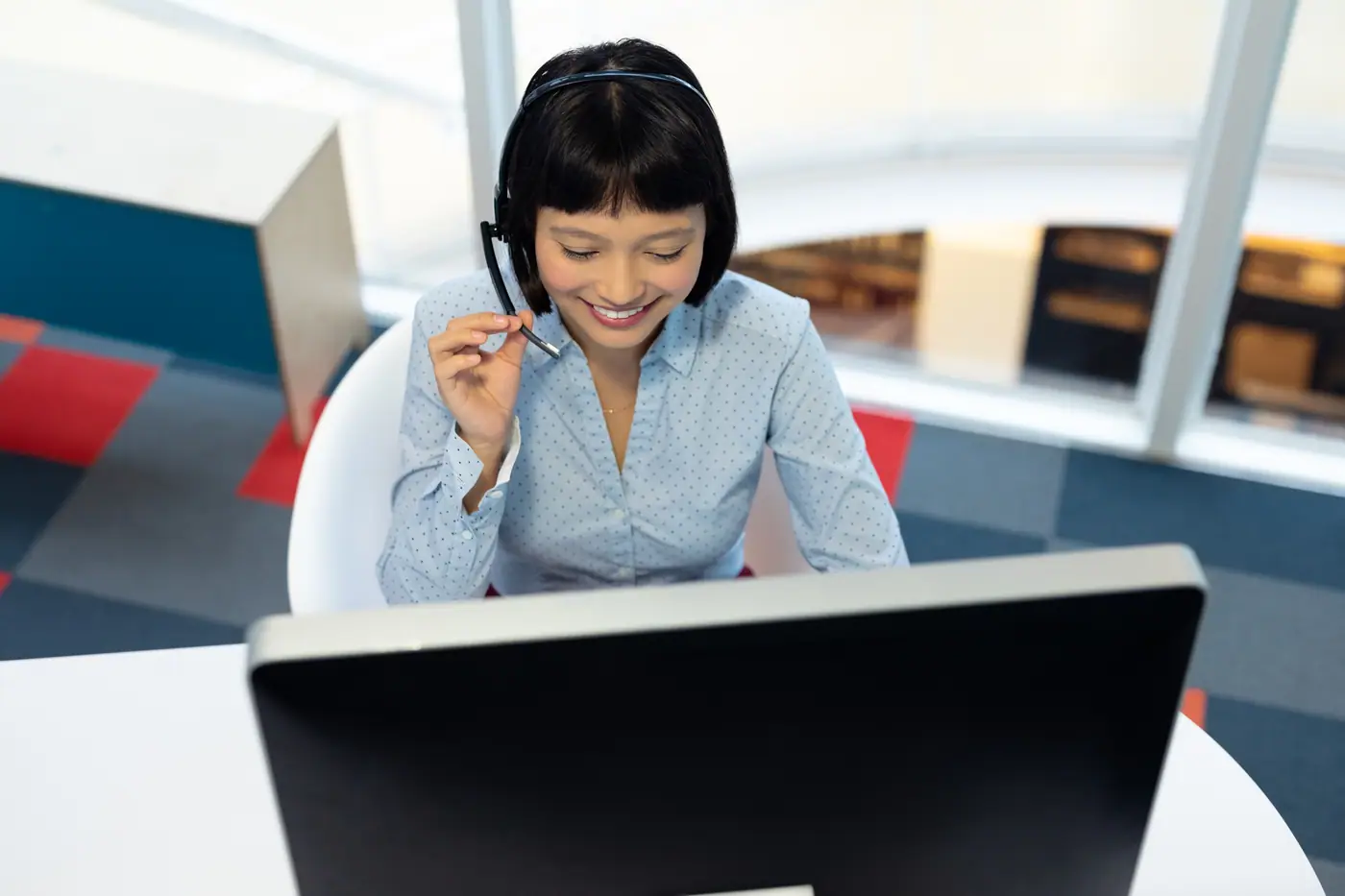 Reservations executive on a headset call at her desk