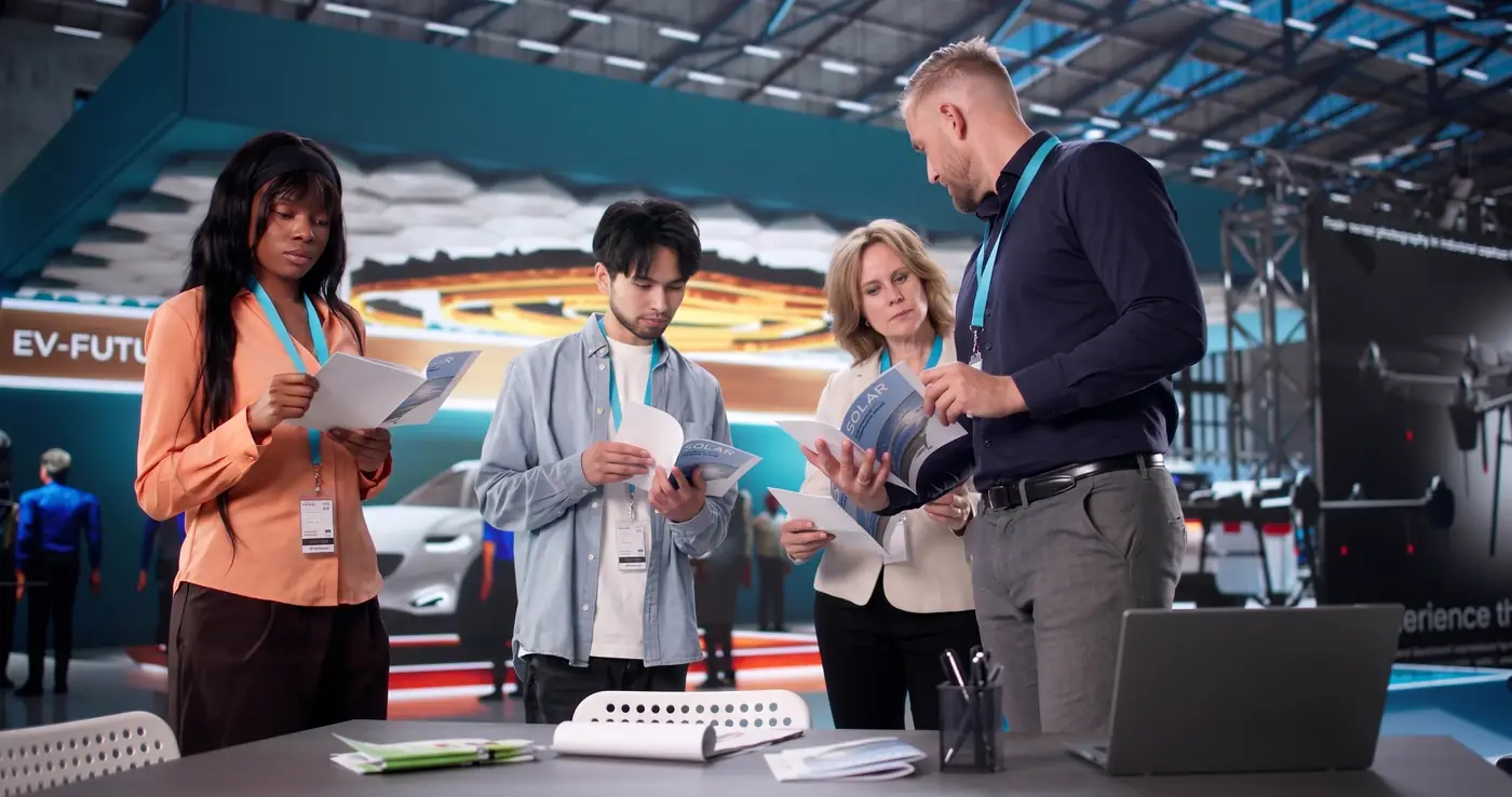 Team reviewing brochures at a trade show booth
